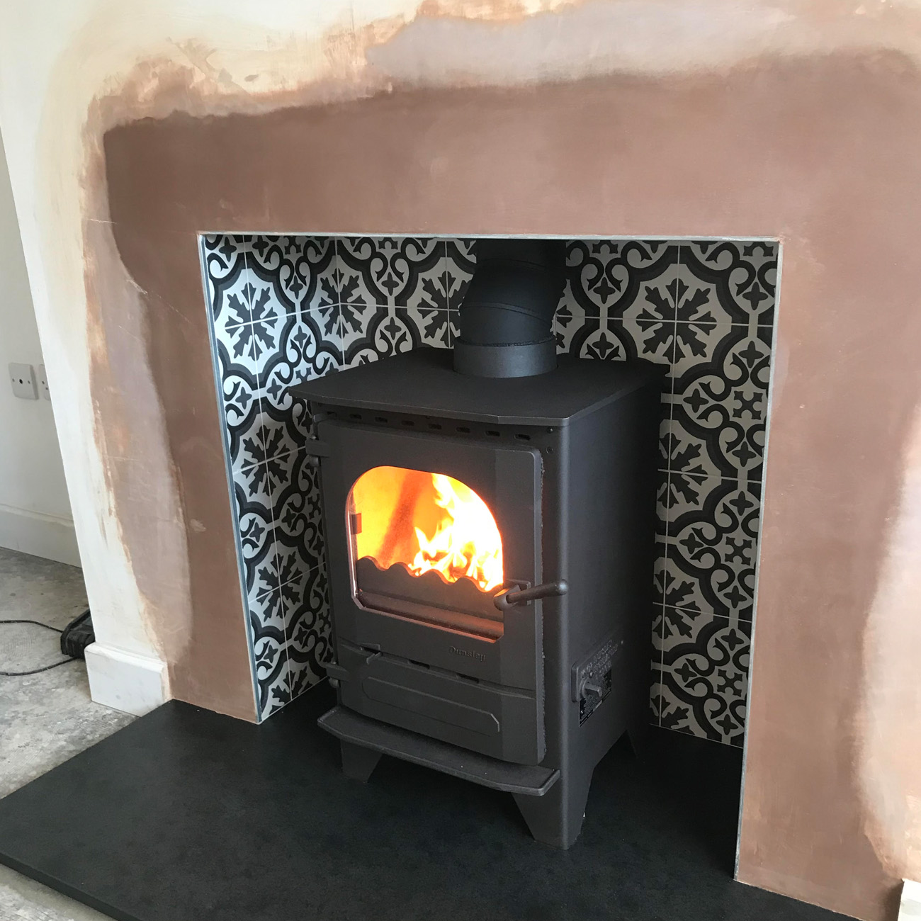 Patterned tiled recess fitted by Firebug Bristol